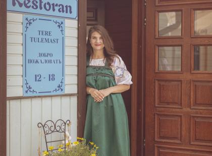 Kolkja Kala- ja sibularestoranin työntekijä kansallisasussa ovella.